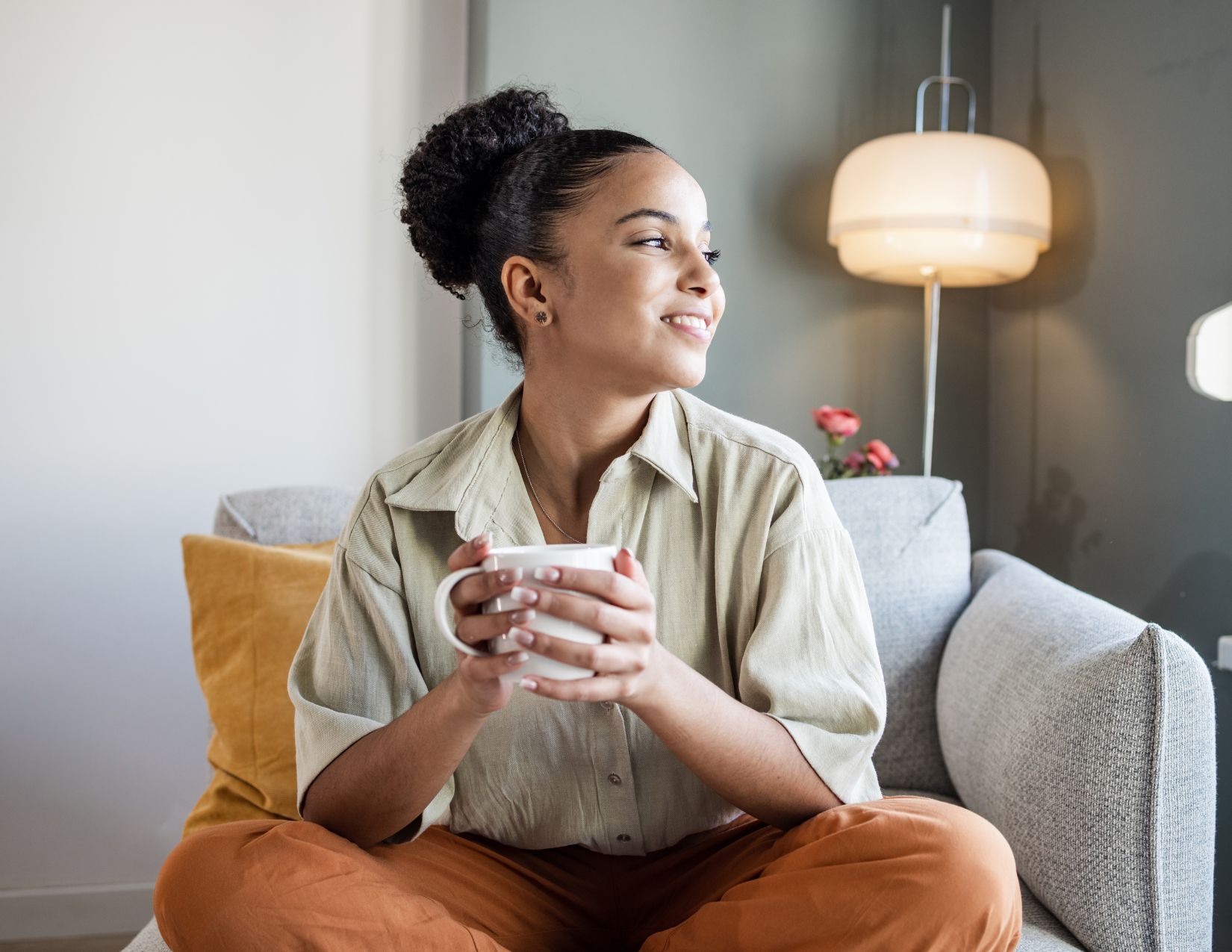 Young BIPOC woman enjoying coffee